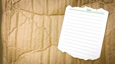 Aged note paper with burnt edges on cardboard background Stock Photos