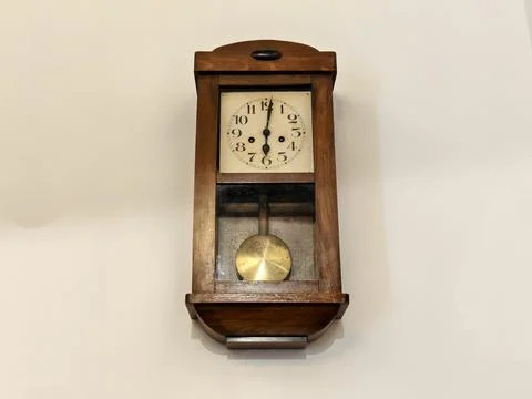 Aged oak pendulum clock scene, nostalgic vintage clock showcasing timeless Stock Photos