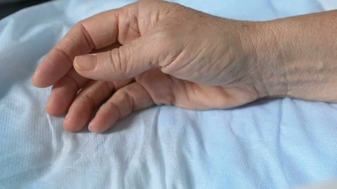 Aged patient squeezing sheets suffering strong pain, serious illness, convulsion Stock Footage 119299042