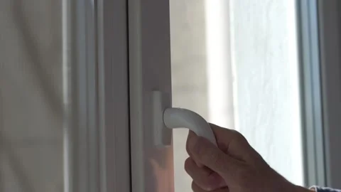 Aged person hand opens window holding white plastic handle Video stock 133888845