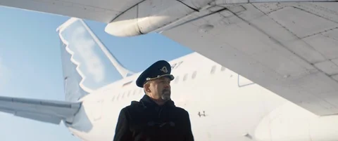 Aged pilot or aviator in cap walking under the wing of aircraft or aeroplane Stock Footage 123259419