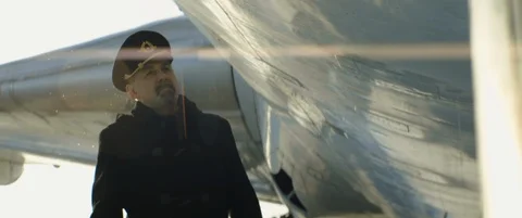Aged pilot or captain walking and touches the body of aircraft or airplane Stock Footage 120341560