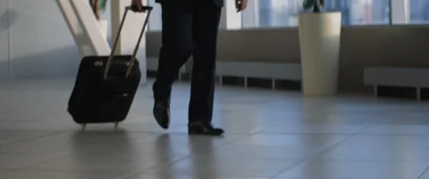 Aged pilot or train driver with Luggage walking by airport or train station Stock Footage 120341592