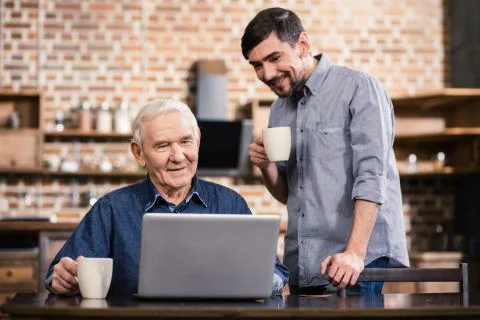 Aged pleasant man using his laptop Stock-Fotos