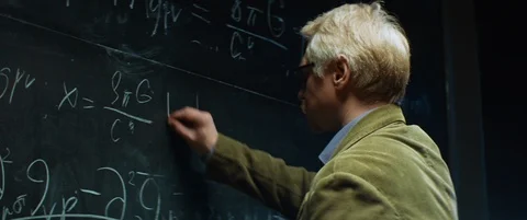 Aged Professor or scientist working, writing characters with chalk on chalkboard Stock Footage 123186546