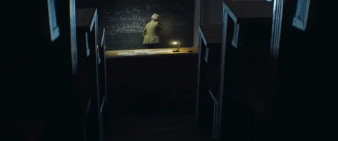 Aged professor writes formula with chalk on blackboard in university classroom Stock Footage 123126599