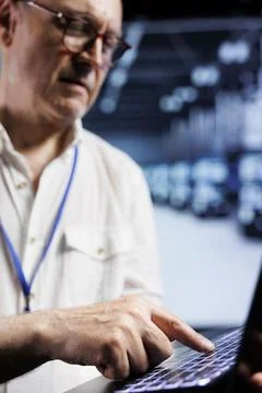 Aged programmer examining servers Stock Photos