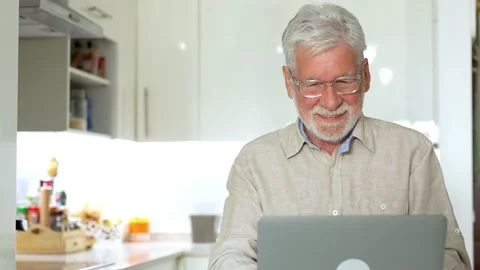 Aged remote worker. Concentrated senior male in glasses work on laptop from.. Stock Footage 236928469