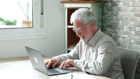 Aged remote worker. Concentrated senior male in glasses work on laptop from.. Stock Footage 236928652