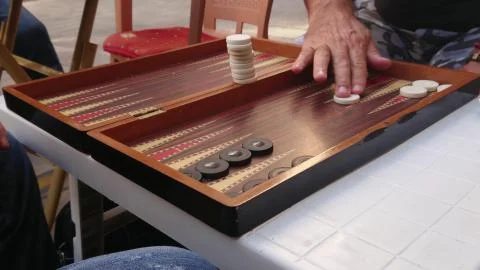 Aged retired men playing backgammon in the outside. Stock Photos