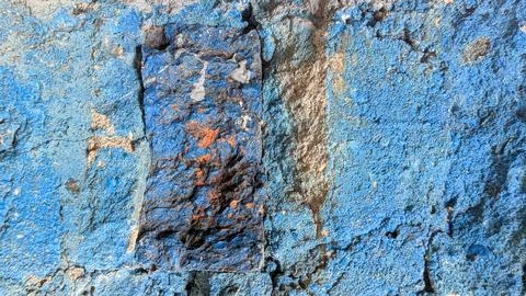 Aged, rough concrete texture wall painted in two shades of blue. Features a.. 库存照片