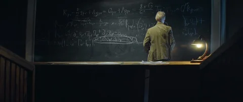 Aged scientist or Professor writing and erasing formula on blackboard Stock Footage 123126657