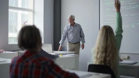 Aged teacher asking students pointing at projector screen Stock Footage 142491417