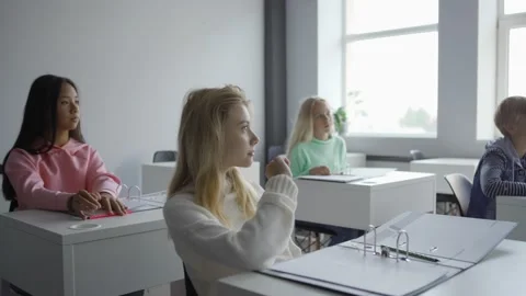 Aged teacher talking to students explaining computer coding Stock Footage 142492205