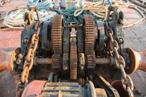 Aged technology: old and rusty gearwheel on an old ship - retro and vintage l Stock Photos