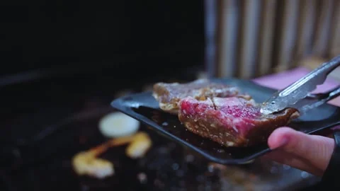 Aged Wagyu Beef Being Picked Up with Tongs for BBQ Stock Footage 340780660