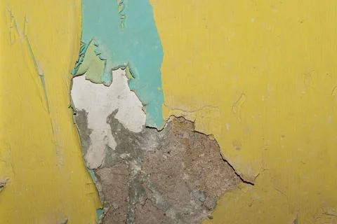 Aged wall texture with peeling paint in turquoise and yellow colors closeup 스톡 사진