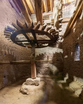 Aged water mill turning inside weathered mill building Stock Photos