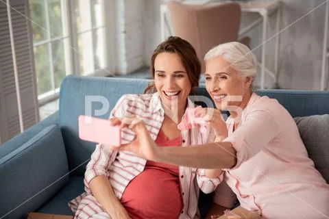 Aged woman feeling memorable making photo with her niece Stock Photos