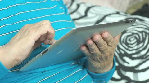 Aged woman using a computer tablet Stock Footage 67218703