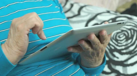 Aged woman using a computer tablet Stock Footage 67844109