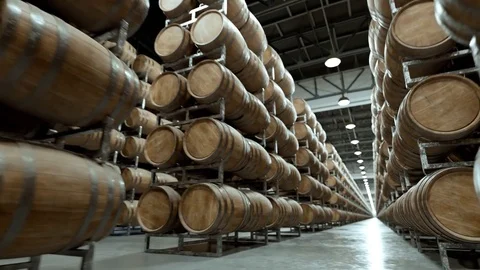 Aged Wooden barrels with a wine or whiskey in a big warehouse Stock Footage