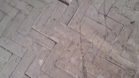 Aged wooden floor with herringbone pattern shown in motion video clip Video stock 337897038