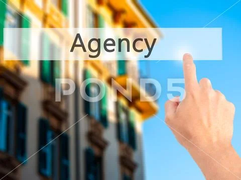 Agency - Hand pressing a button on blurred background concept on Stock Photos
