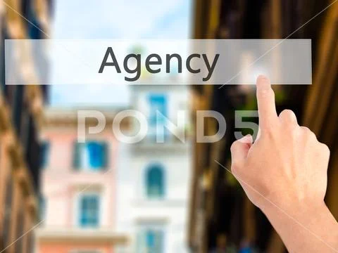 Agency - Hand pressing a button on blurred background concept on Stock Photos