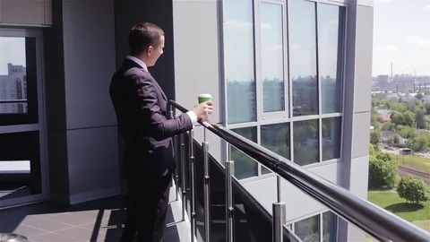 Agency staff are drinking coffee on the balcony of the business center. Stock Footage 70435510