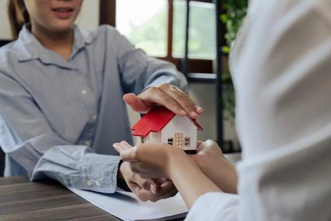 Agent hand cover house model. real estate, insurance and property concepts after Stock Photos