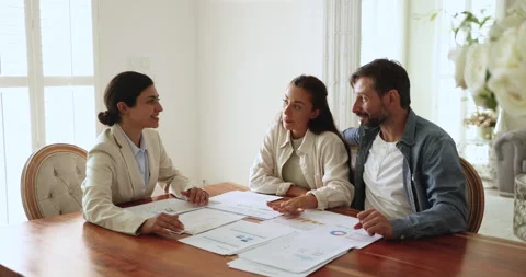 Agent presenting to clients market data during meeting in office Stock Footage 271118327