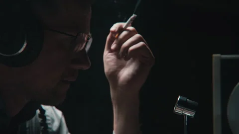 An agent smoking while wire tapping Stock Footage 258219801