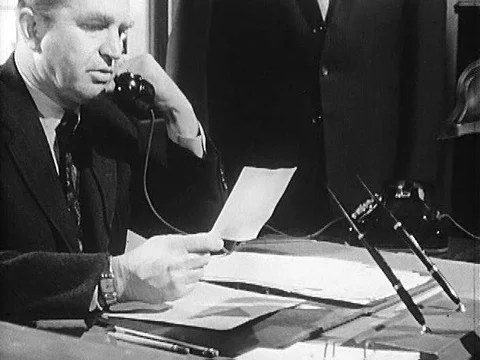 An agent of the US State Department make a call to send a coded message from Stock Footage 75758977