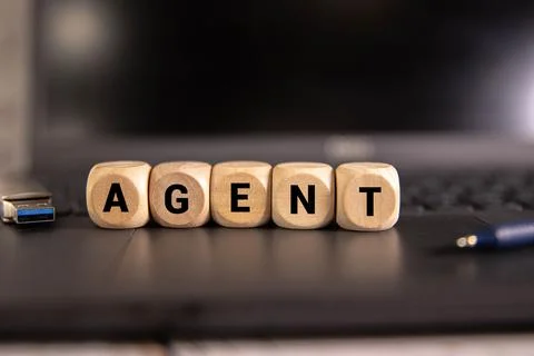 AGENT word made with building blocks on a light background. Stock Photos