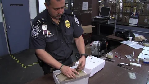 Agents from U.S. customs seize fake prescription drugs at a shipping facility. Stock Footage 74799117