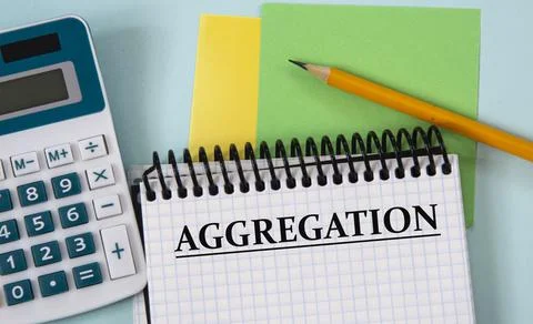 AGGREGATION - word in a white notebook on the background of a calculator, pen Stock Photos