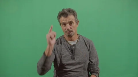 Aggressive adult man executing the viewer with the hand in shape of a gun in Video stock 115342522
