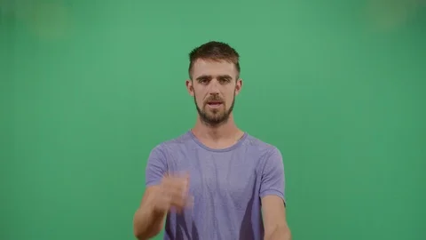Aggressive adult man executing the viewer with the hand in shape of a gun studio Video stock 117981283