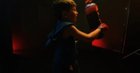 Aggressive boy hitting the punching bag in gym Stock Footage 112077862