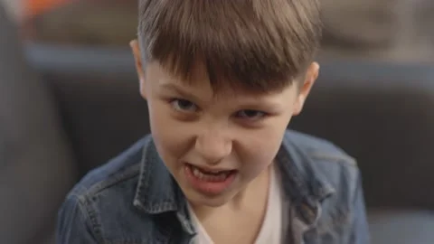 Aggressive boy portrait. Front camera view. 動画素材 148955258