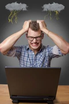 Aggressive boy sitting at the computer Stock Photos