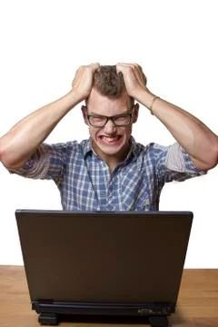 Aggressive boy sitting at the computer Stock Photos