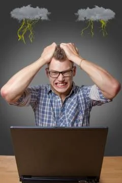 Aggressive boy sitting at the computer Stock Photos