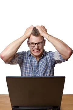Aggressive boy sitting at the computer Stock Photos