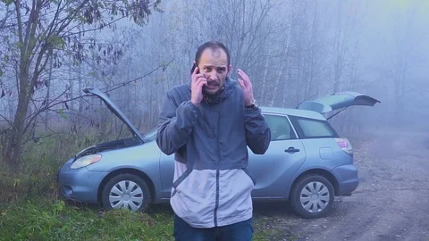 Aggressive driver of an old car yelling into the mobile phone. It's time to Video stock 111738875