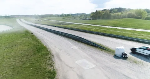 Aggressive dynamic drone shot of racing car Stock Footage 89416313