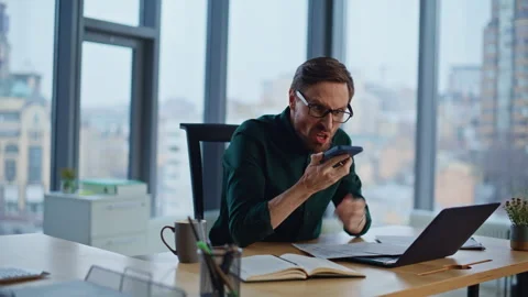 Aggressive executive frustrated call yelling in smartphone at work desk closeup. Stock Footage 340237246