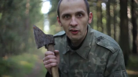Aggressive forest maniac with an axe Stock Footage 90093822