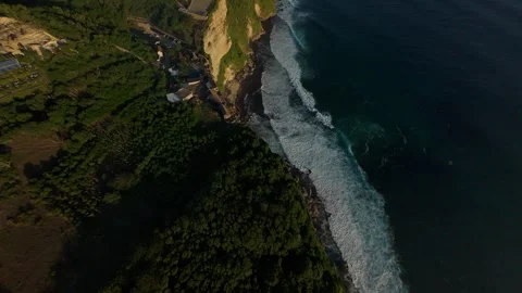 Aggressive FPV Drone Dive Along Karang Boma Cliff Above Ocean Breakers, Dynamic Stock Footage 336636591